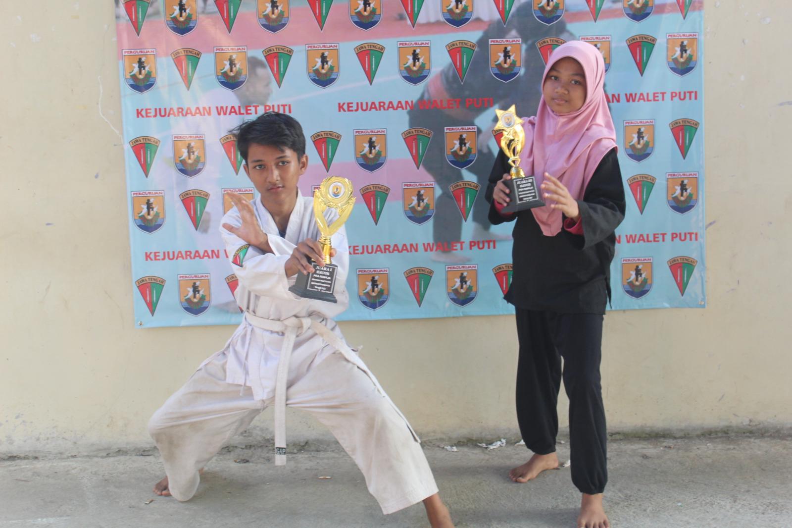 Azmi foto bersama adiknya Rofiffah yang meraih juara 3 di kelas putri usai berlaga di Kejuaraan Pencak Silata Waletputi 2023 di SMP Negeri 2 Bukateja.