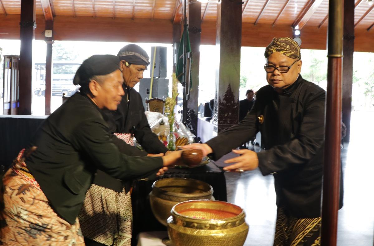 Pj Bupati Banjarnegara Tri Harso Widirahmanto membersihkan salah satu pusaka dalam jamasan pusaka di Pendapa Banjarnegara.